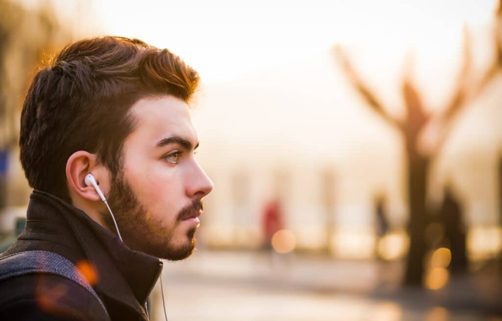 man listening to a podcast