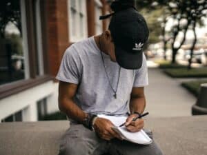 A guy writing in his notebook